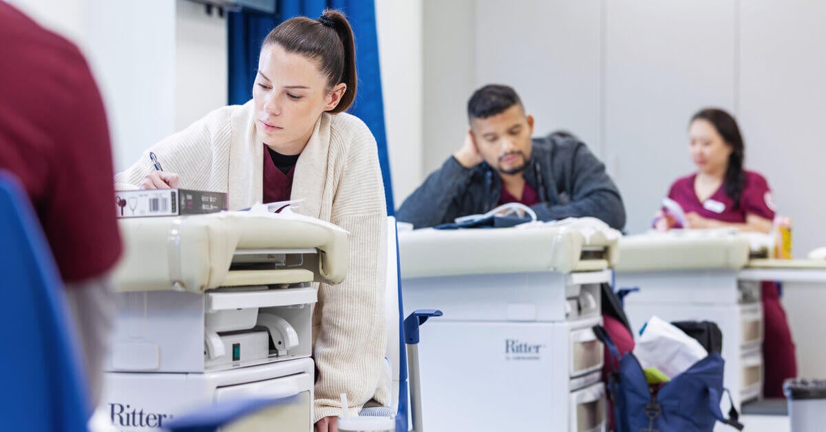 SJC nursing students taking notes